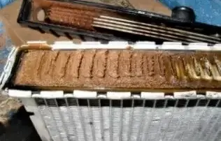 interior of a rusty, dirty-looking car part