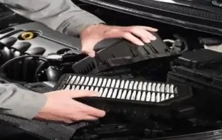 man checking engine air filter