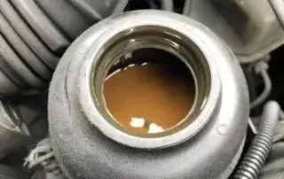 image showing brown power steering fluid can in vehicle