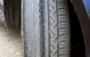 close up image of bad, worn tire tread