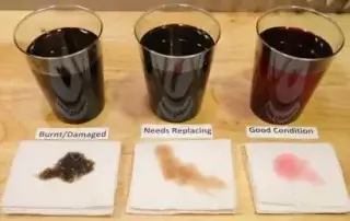 one cup of black, burnt/damaged fluid. one cup of brown fluid that needs replaced. one cup of red, good condition fluid